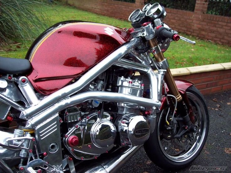 a red motorcycle is parked on the street