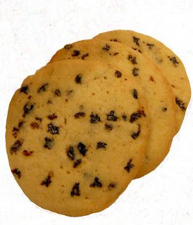 three chocolate chip cookies sitting on top of each other in front of a white background