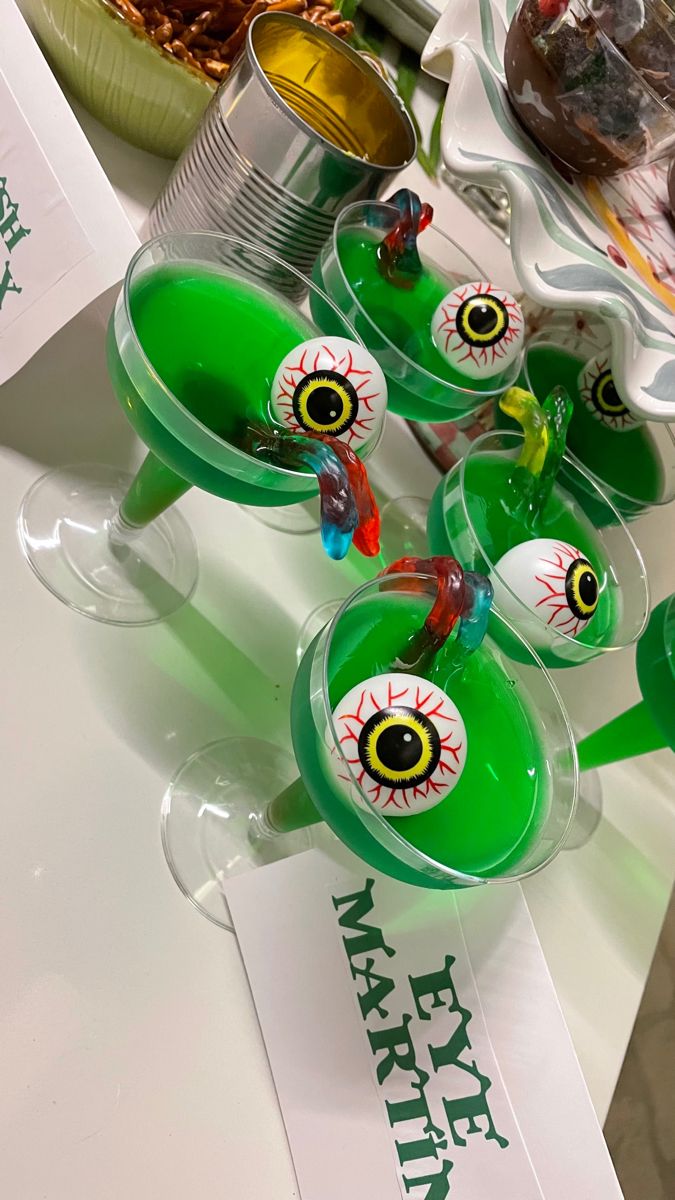 green glasses with eyeballs on them sitting on a table