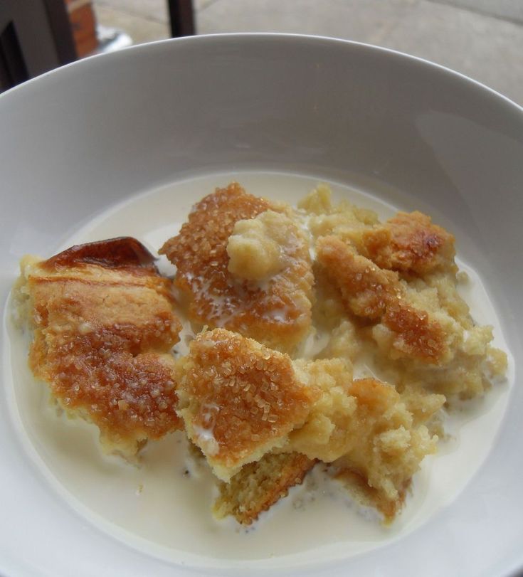 a white bowl filled with food on top of a table