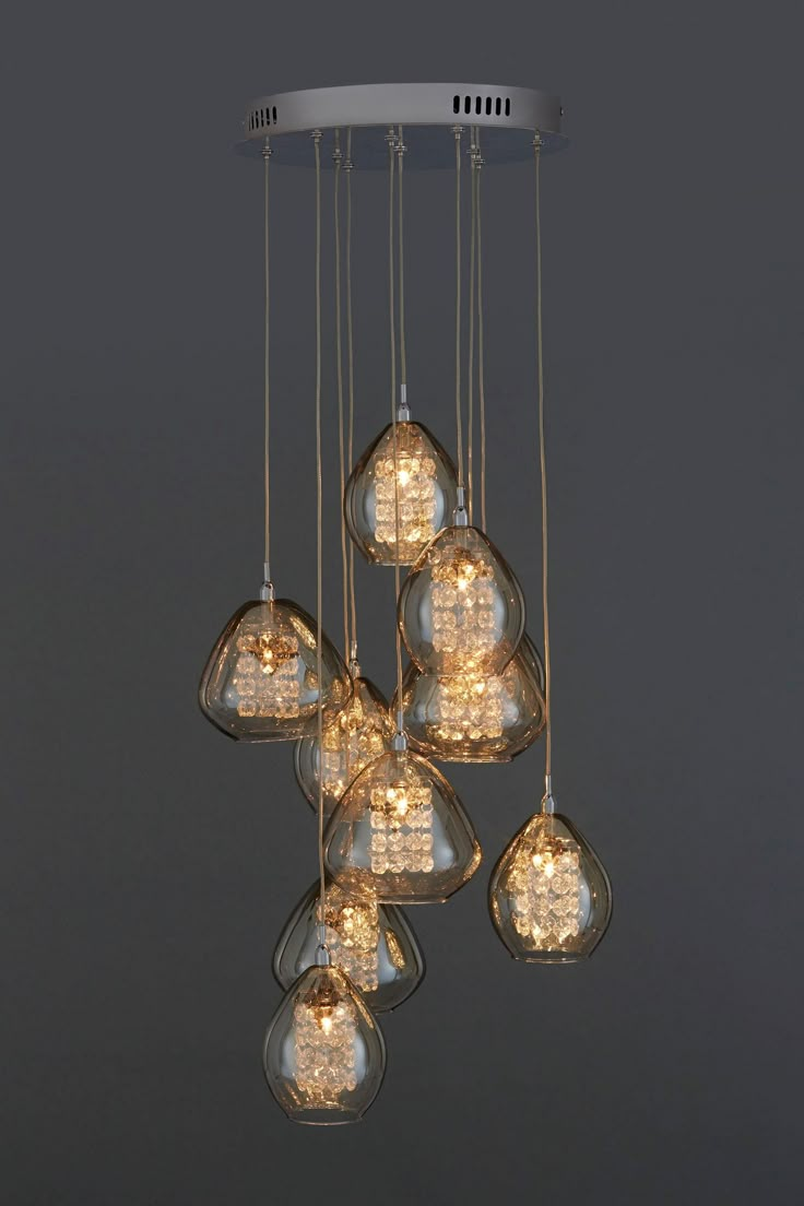 a chandelier with many lights hanging from it's sides and some bulbs on the