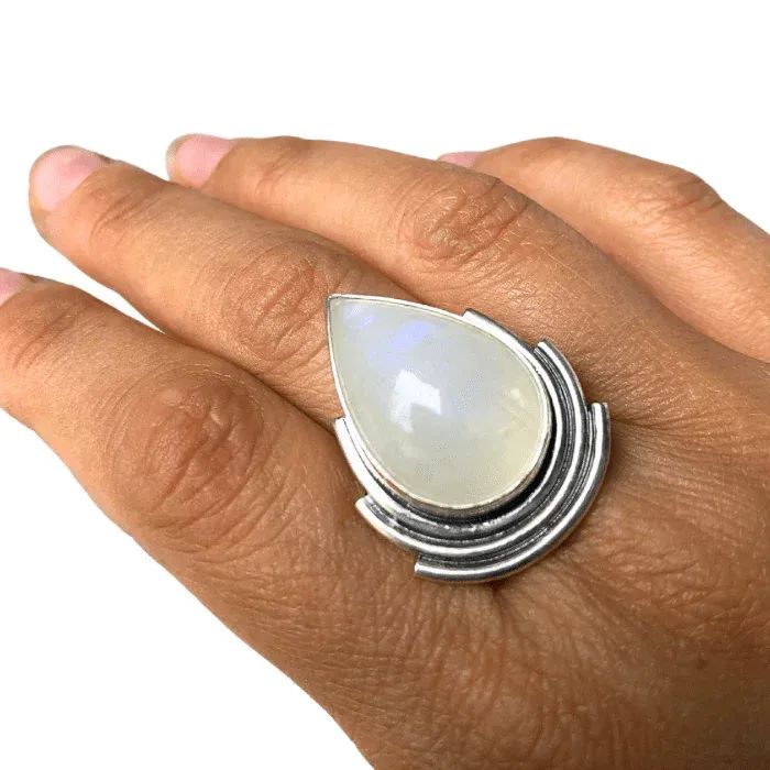 Dive into the world of moonstones as you explore the enchanting Cascading Moonstone Ring. This captivating ring, featuring a stunning cascade of silver hugging a teardrop shaped moonstone, adds a touch of whimsy and elegance to your jewelry collection. Explore the magic and lore surrounding moonstones, and see how this mystical gemstone can elevate any outfit. Cosmic Jewelry, Moonstone Rings, Stacker Rings, Simple Band, Gemstone Cabochons, Moonstone Ring, Moon Stone, Jewelry Care, Moonstone