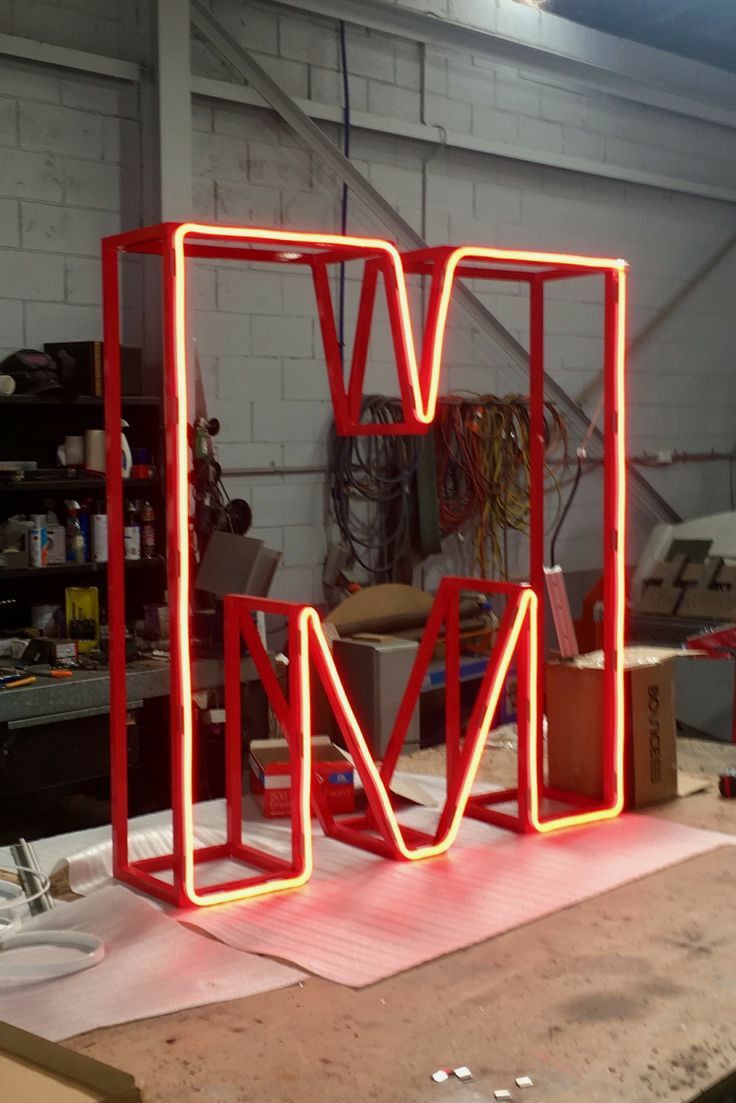 a red sculpture sitting on top of a wooden table