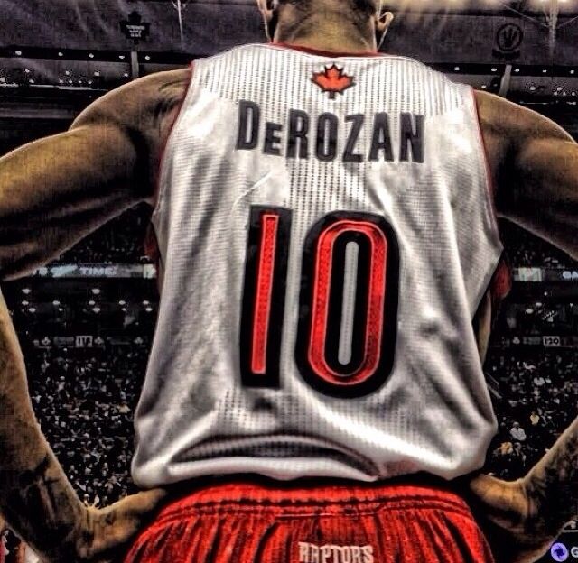 the back of a basketball player with his hands on his hips in front of an arena