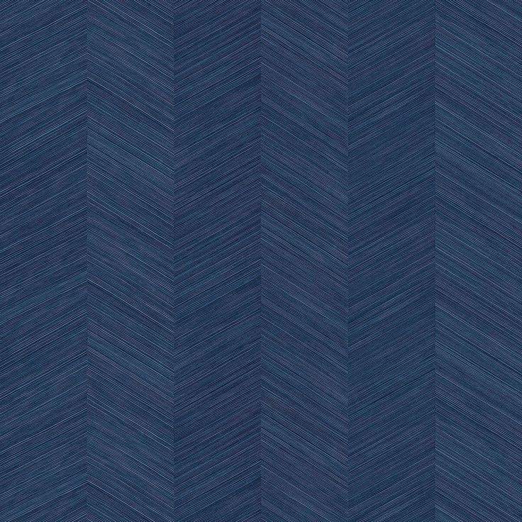 a blue chevroned wallpaper pattern that looks like it has been painted in different shades