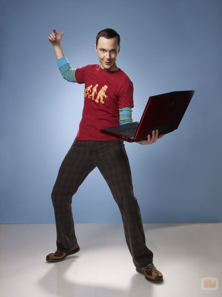 a man holding a laptop in his right hand and standing on one leg with both hands up