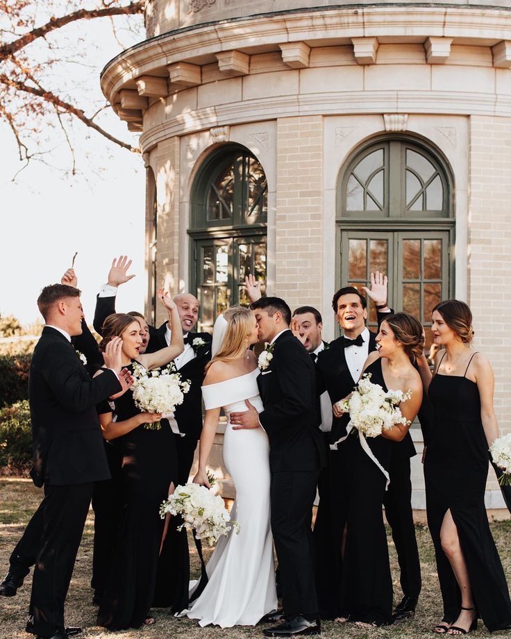 a group of people standing next to each other in front of a building