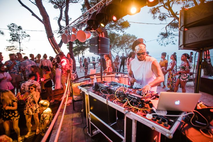 a dj mixing music in front of a crowd