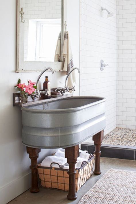 a bathroom sink sitting under a mirror next to a walk in shower