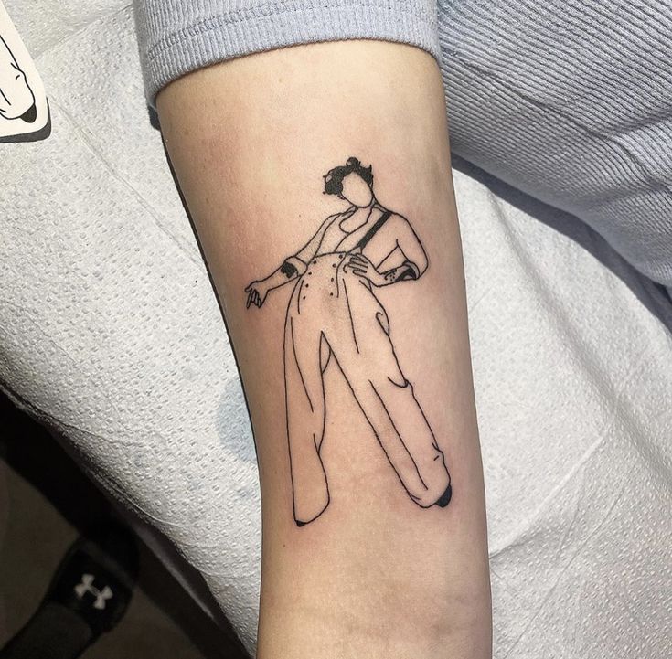 a woman's arm with a black and white drawing of a man on it