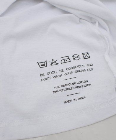 a white t - shirt with instructions to wash clothes