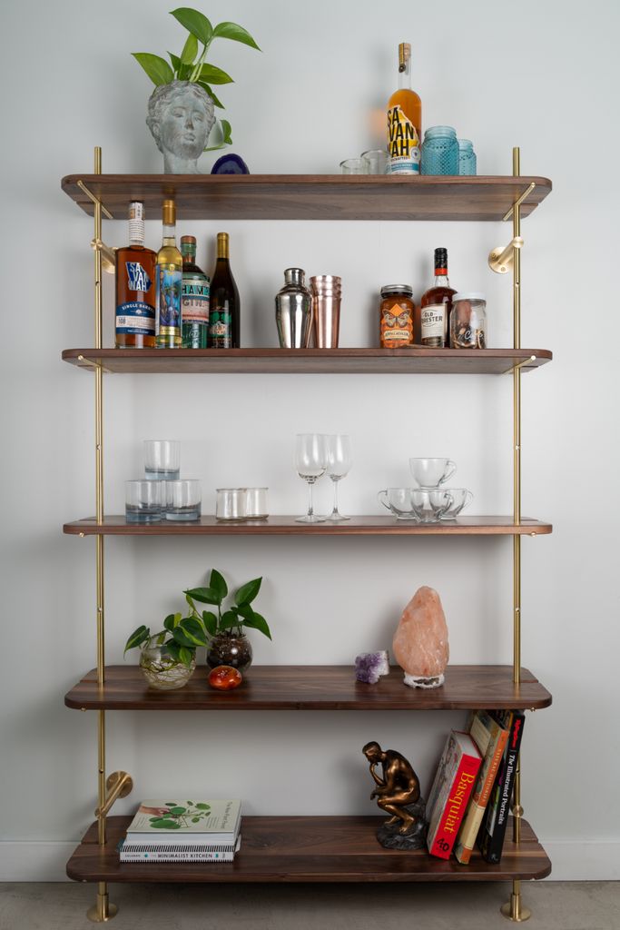 the shelves are filled with bottles, glasses, and other items on it's sides