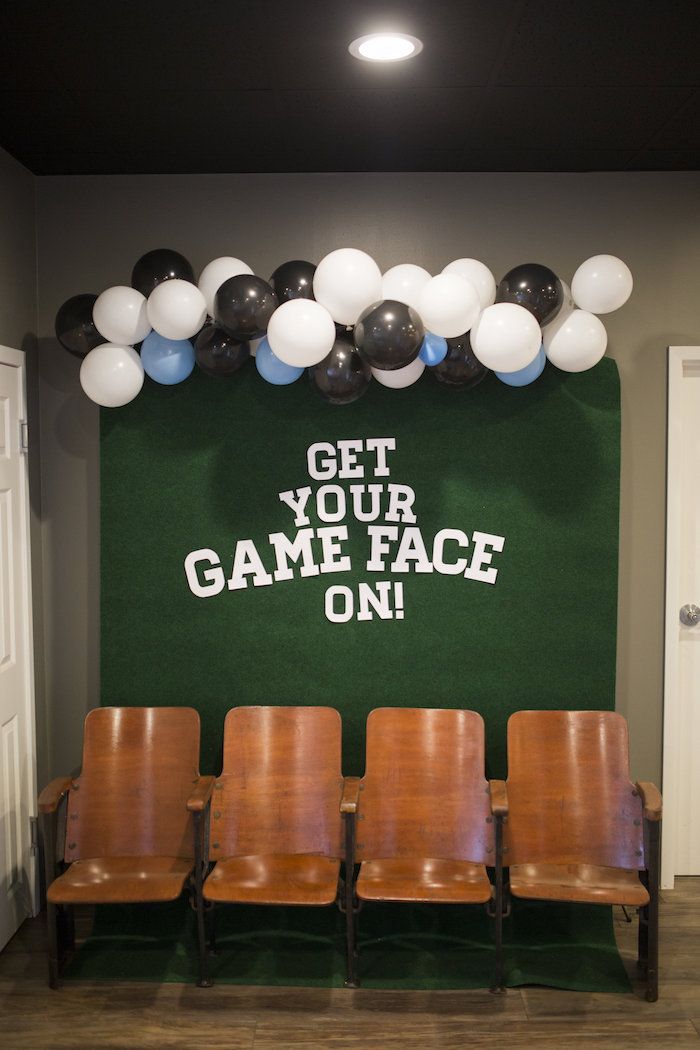 a game room with chairs and balloons on the wall