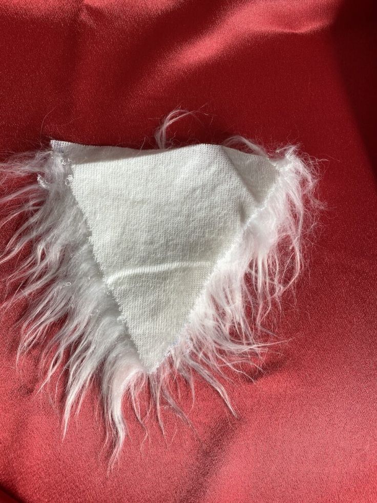 a piece of cloth with white feathers on it