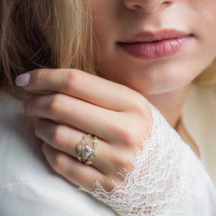 a close up of a person wearing a ring and holding her hand on her shoulder