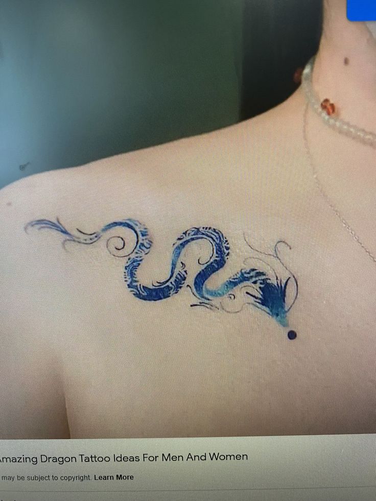 a woman with a dragon tattoo on her back