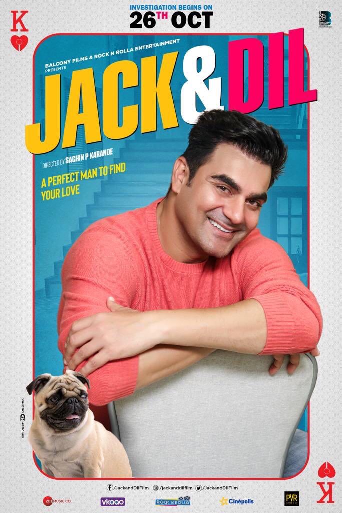 a man sitting on top of a chair next to a pug in front of a poster