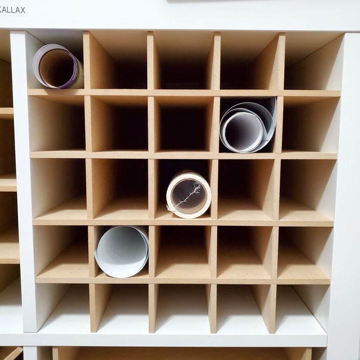 the shelves have cups and bowls in them for storage on top of each other,