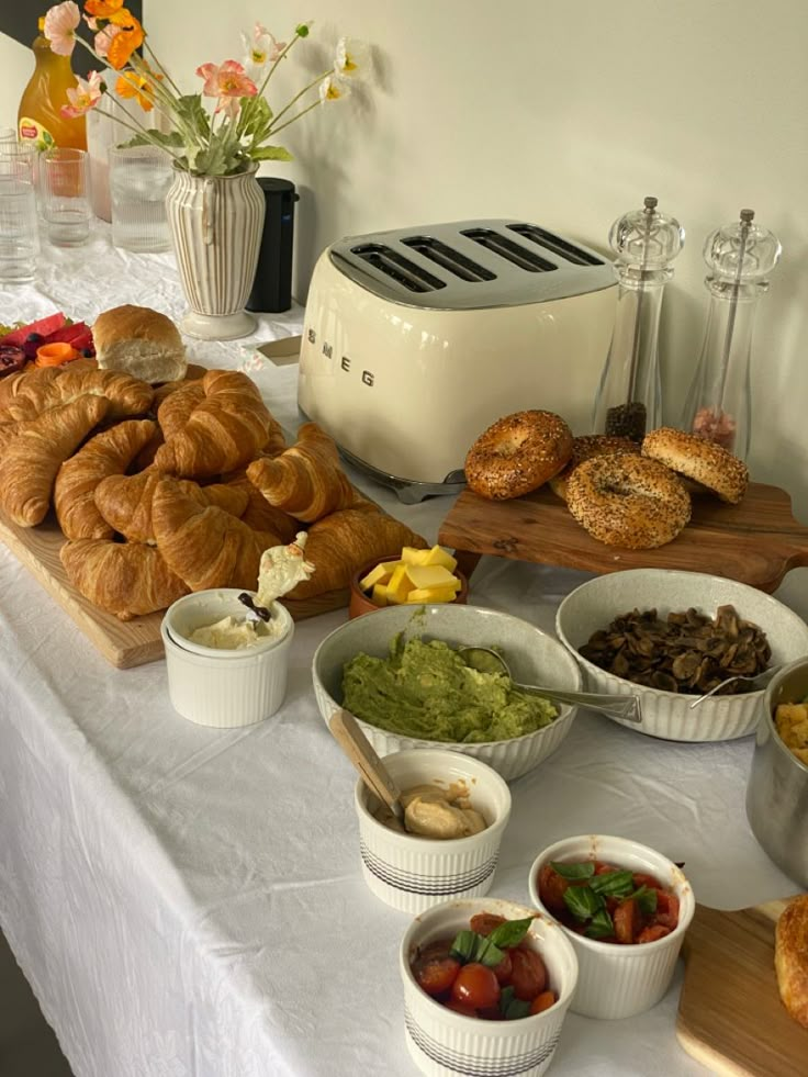 the table is full of breads, vegetables and other food items on it's side