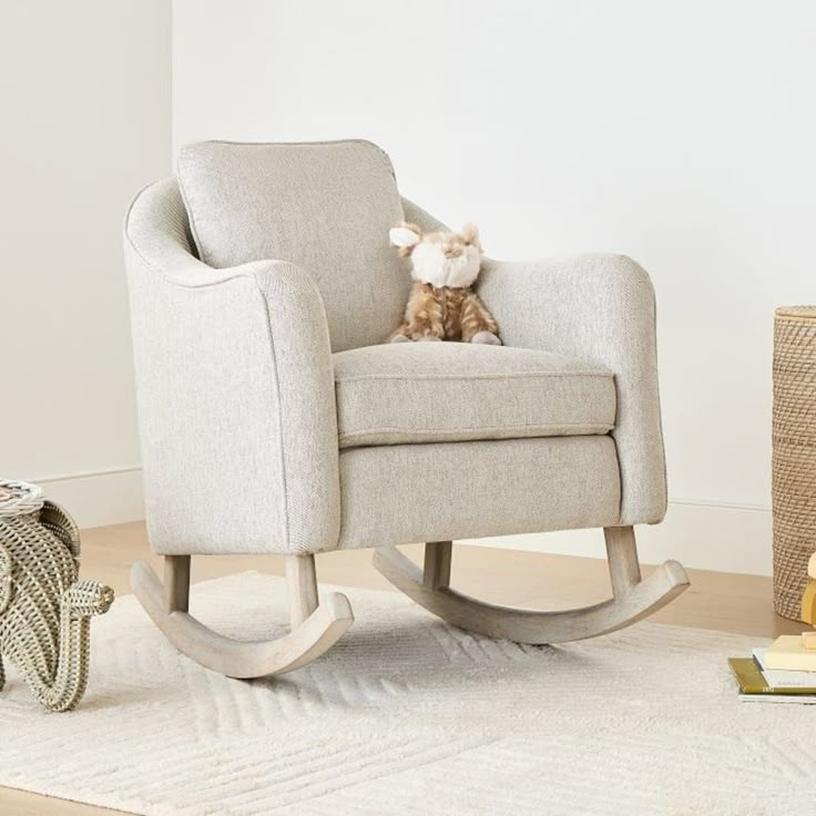 a rocking chair with a stuffed animal on it's back in a living room