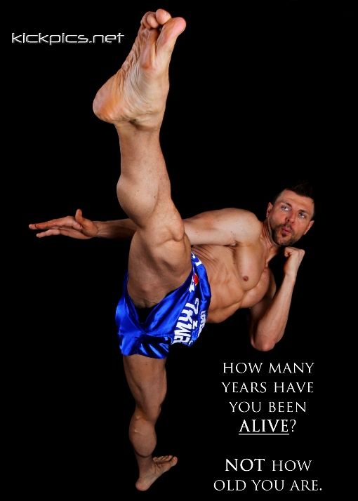 a man in blue shorts doing a kickbox pose with his leg up and the words, how many years have you been alive? not how old you are