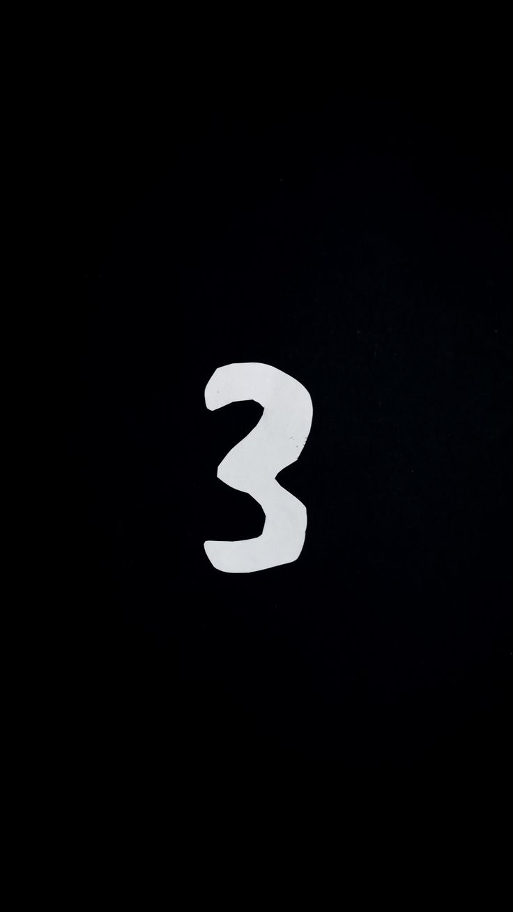 the number three is written in white on a black background