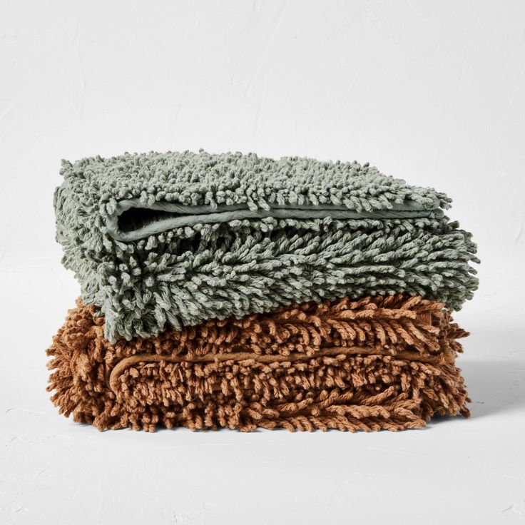 three different colored towels stacked on top of each other