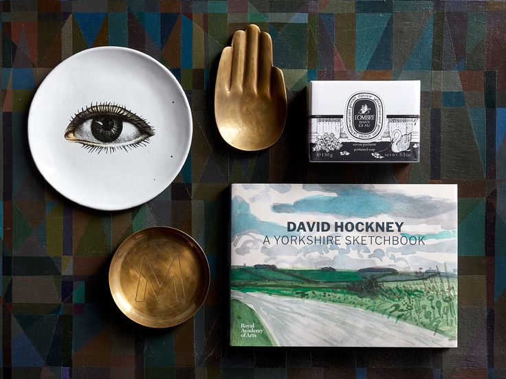 a table topped with plates and silverware next to a book