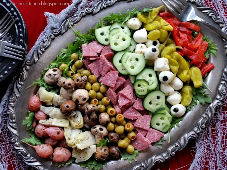 a platter filled with lots of different types of food on top of a table