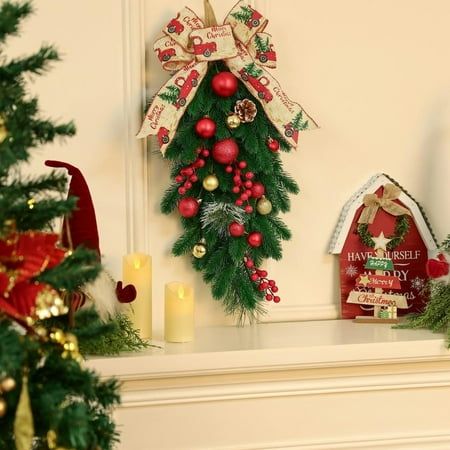 a christmas wreath is hanging on the mantle