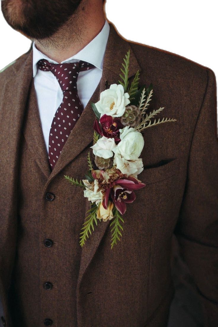 a man in a suit with flowers on his lapel