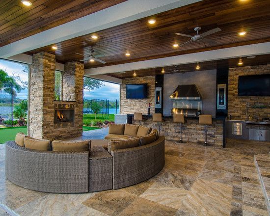 an outdoor living area with couches, television and pool in the backround