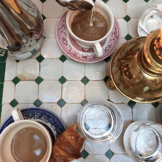 two cups of coffee are being poured into the mugs on top of each other