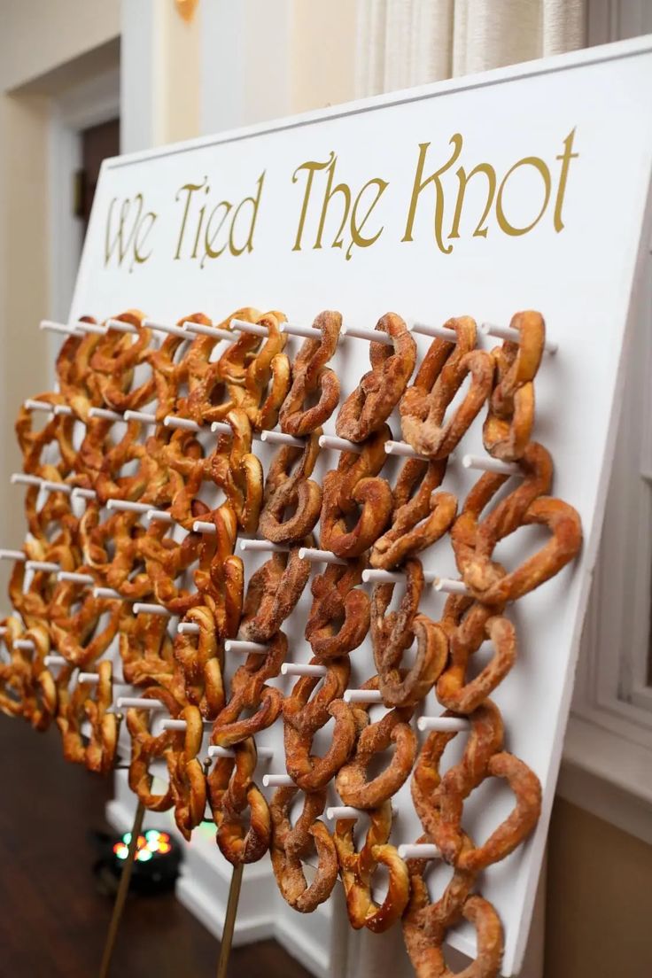 there are many pretzels that are on the table and in front of a sign