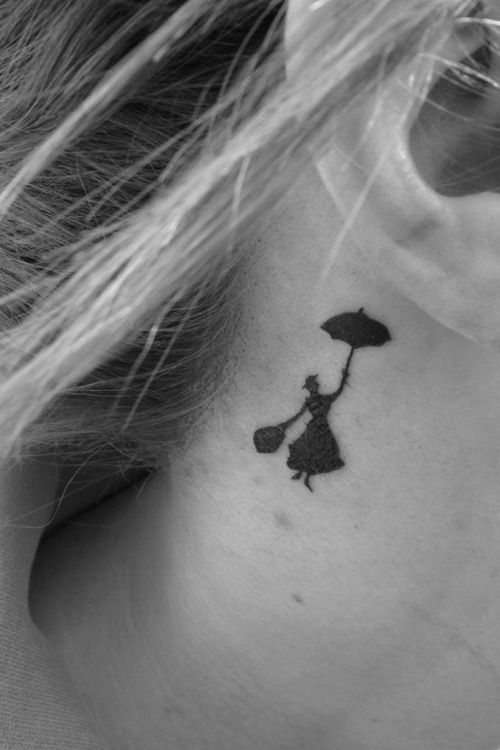 a woman's neck with a small tattoo of a girl holding an umbrella