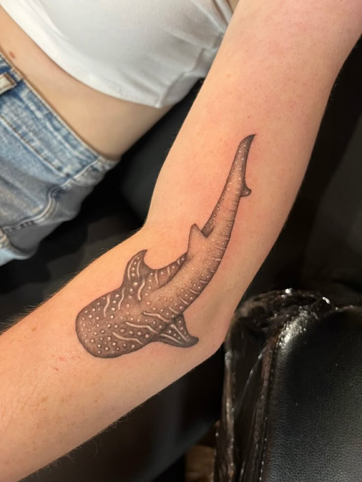 a woman with a tattoo on her arm that has an elephant's head in it