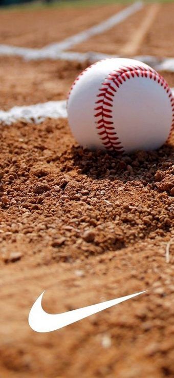 a baseball sitting on top of a dirt field