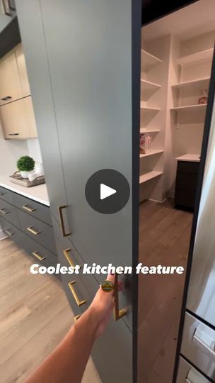 a person is opening the door to a kitchen that has built in shelving units