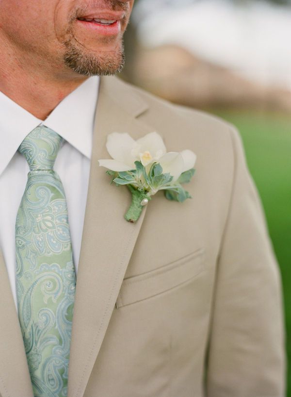 a man in a suit with a flower on his lapel