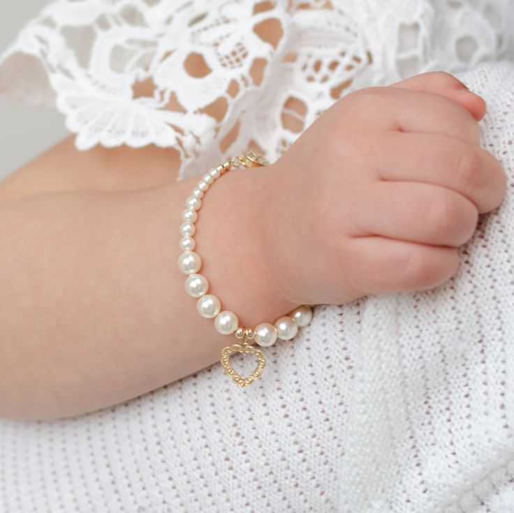 a close up of a child's arm wearing a bracelet