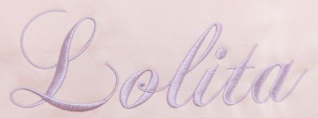 an embroidered name on a white shirt that says, bollita in cursive writing