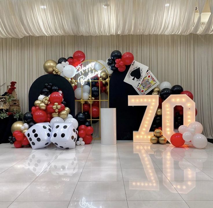 a room with balloons and decorations on the floor for an 70th birthday party or celebration