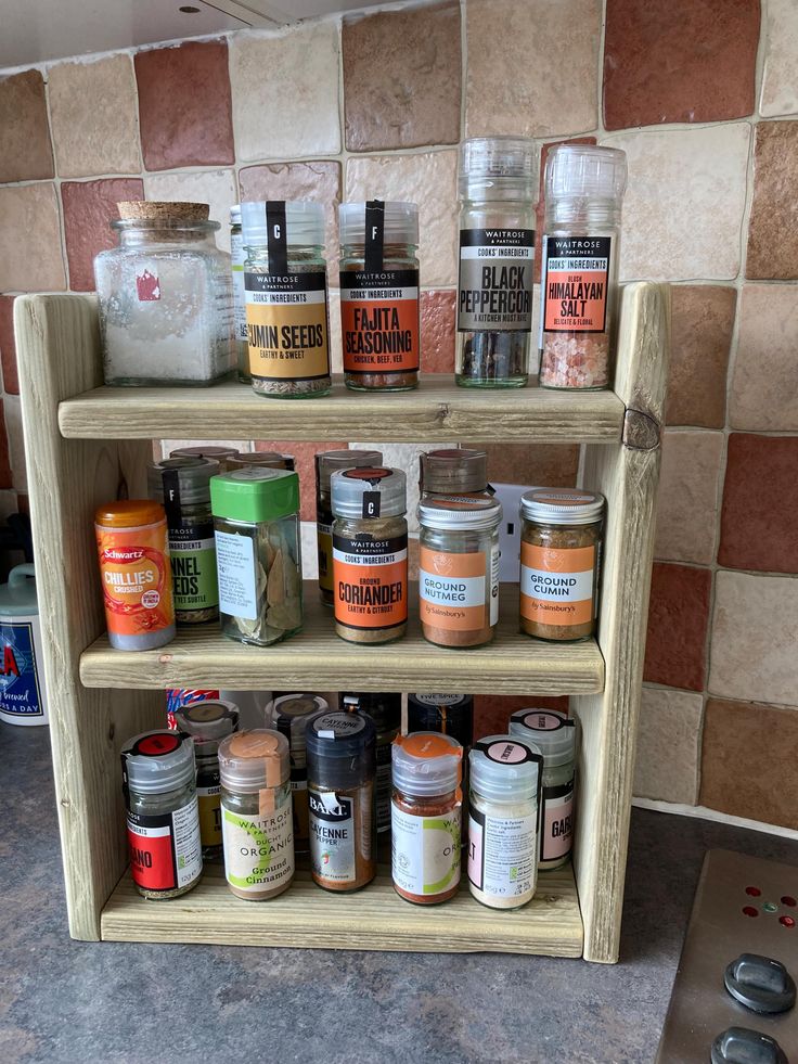 the spice rack is filled with many different types of spices