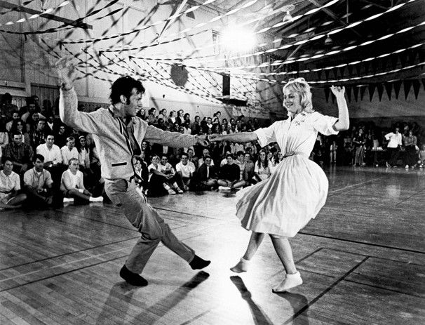 two people dancing on a dance floor in front of an audience