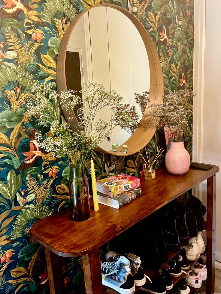 a wooden table topped with a mirror and lots of shoes