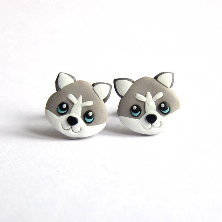 pair of earrings with grey and white dog's head on top of each ear