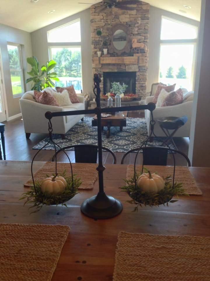 a living room filled with furniture and a fire place in the middle of a room