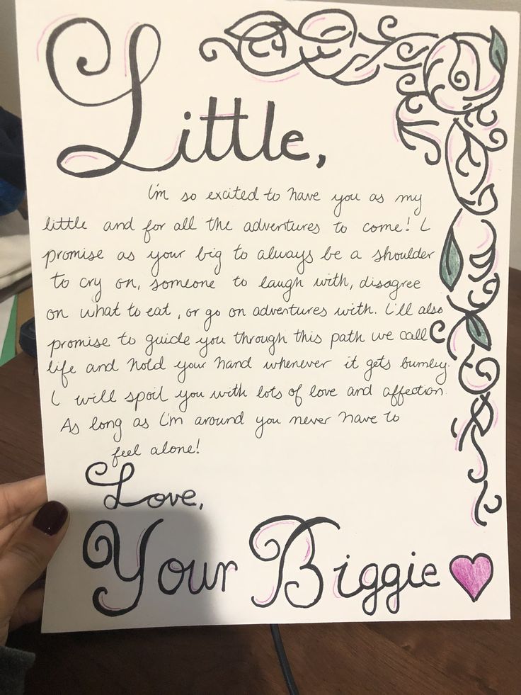 someone is holding up a letter to their daughter