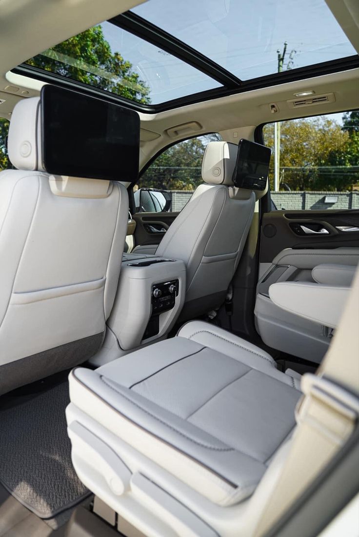 the interior of a car with its sunroof and rear seats folded down in front of it