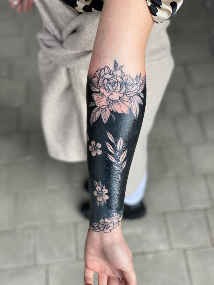 a person with a flower tattoo on their arm